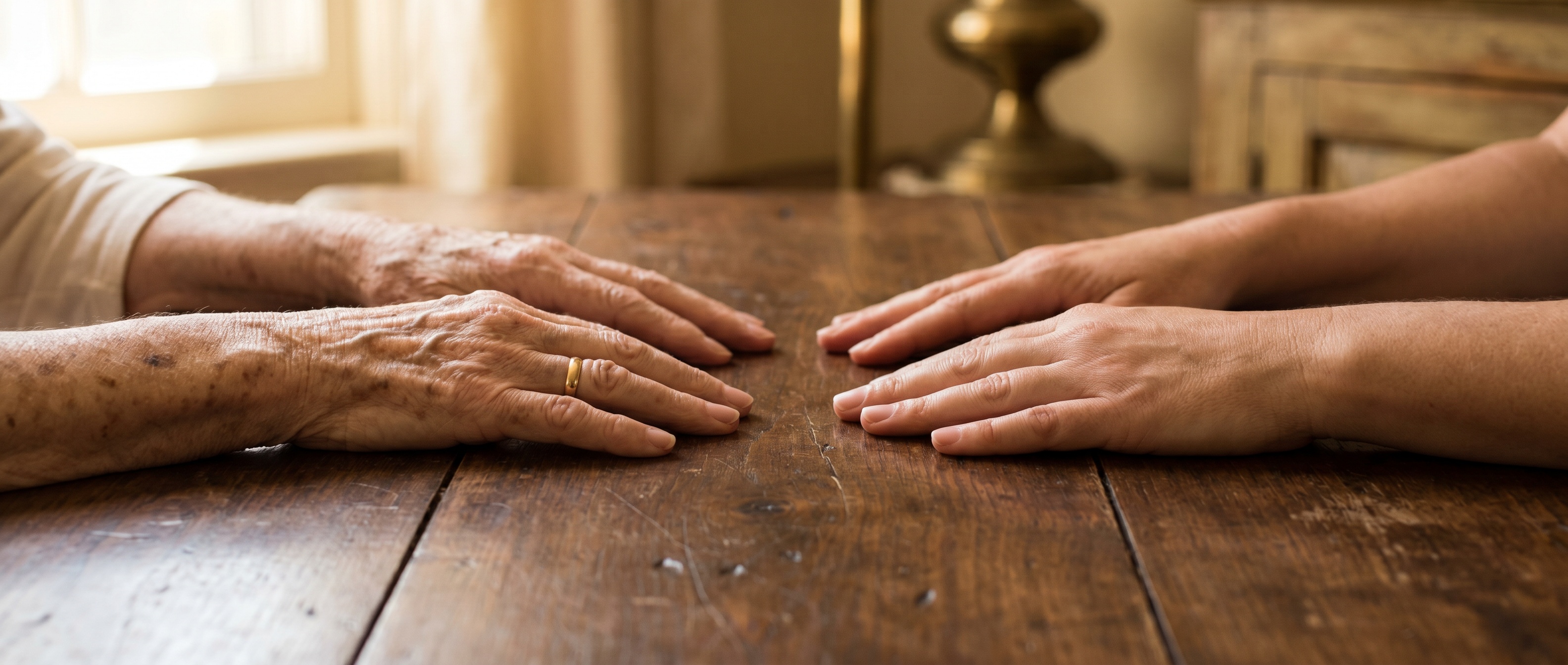 Hands of two generations resting on a Kentucky walnut tabletop.